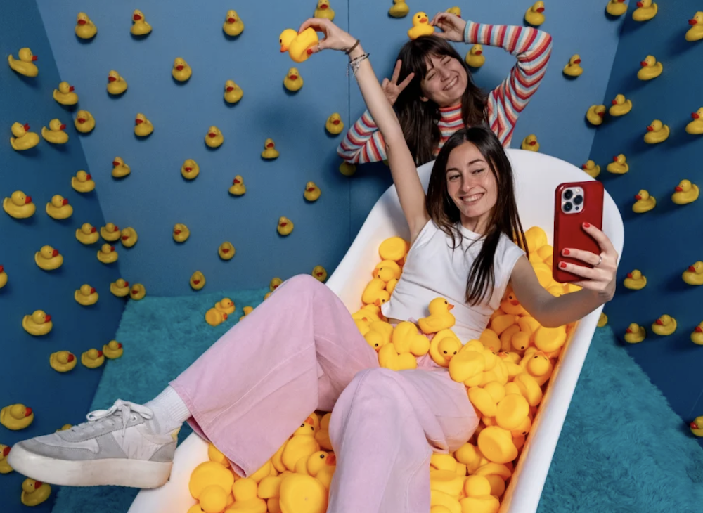 Bubble Planet Manchester duck room with bath and people taking selfies