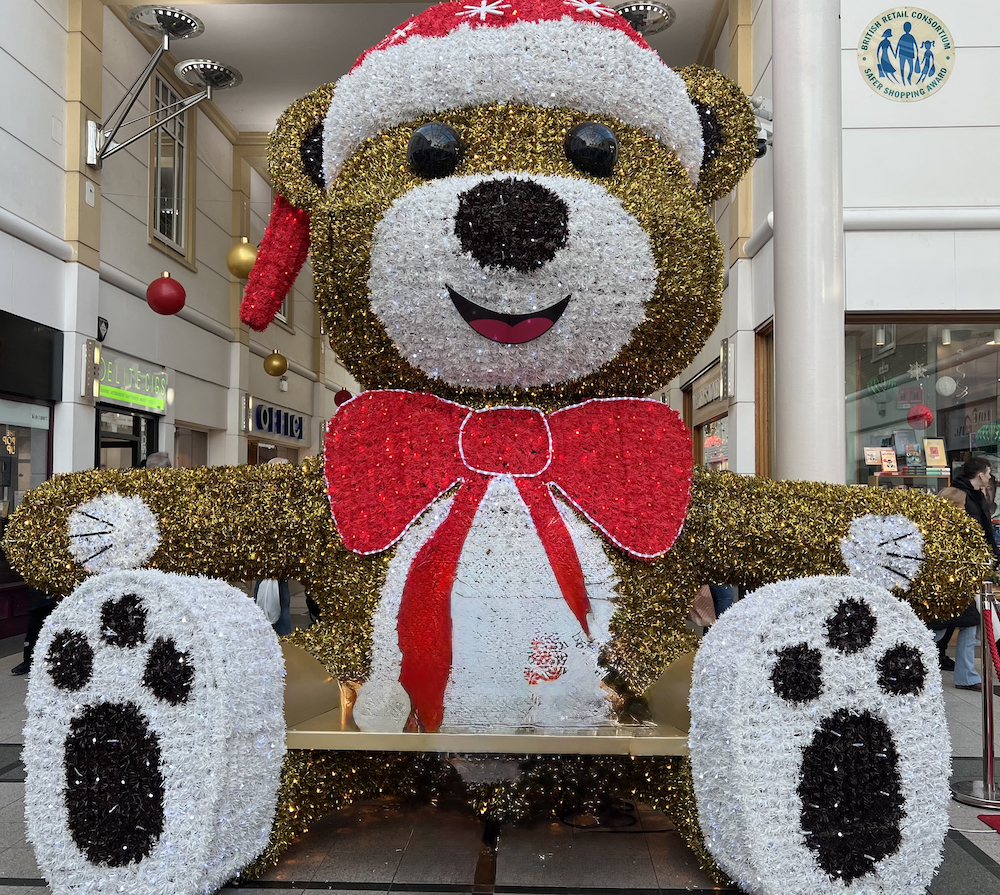 Christmas Light Switch On Stockport a large light up teddy bear with a santa hat on