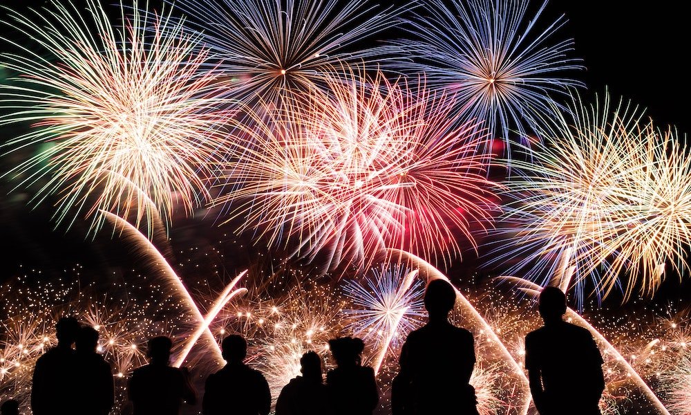 people watching fireworks in the sky