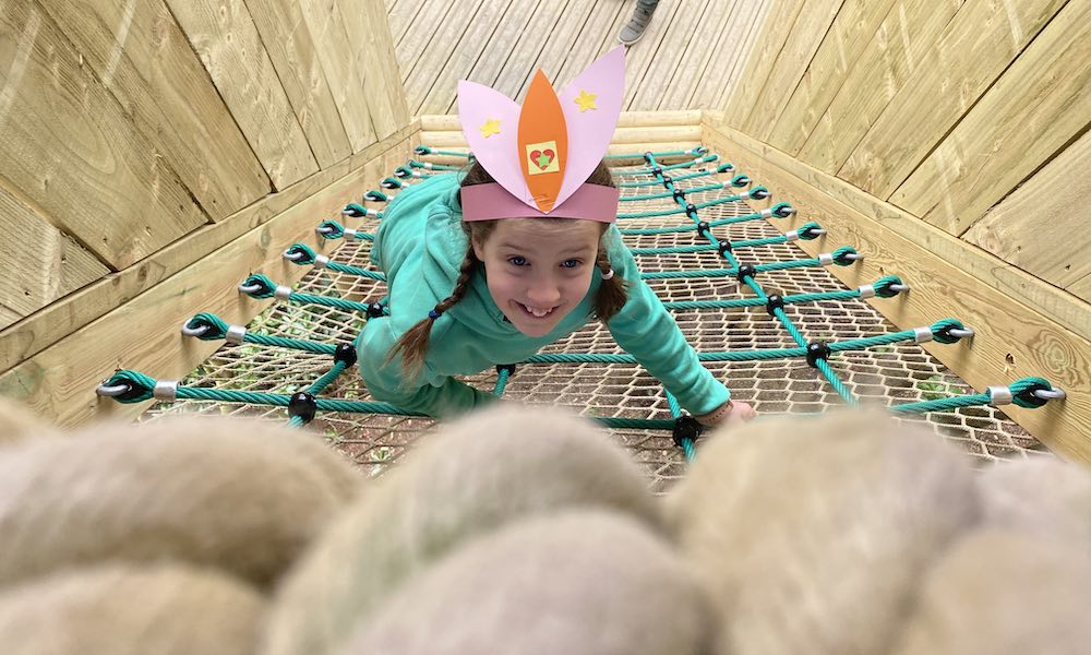 a child climbing at BeWILDerwood Cheshire