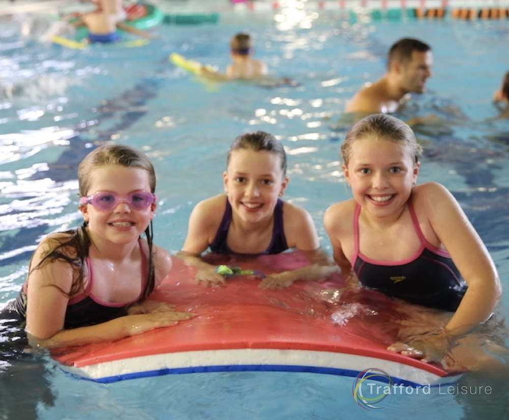 three children on a float on a Swimming Party Stretford Sports Village - Credit Trafford Leisure
