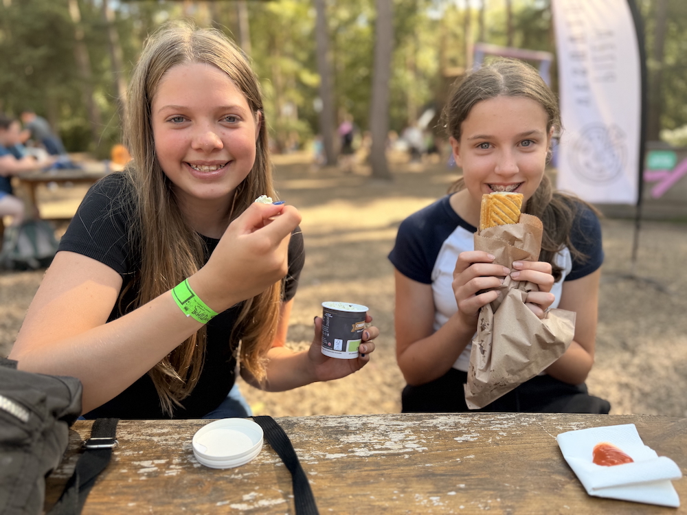 Top tips BeWILDerwood Cheshire - Food two girls one eating icecream and one eating a sausage roll