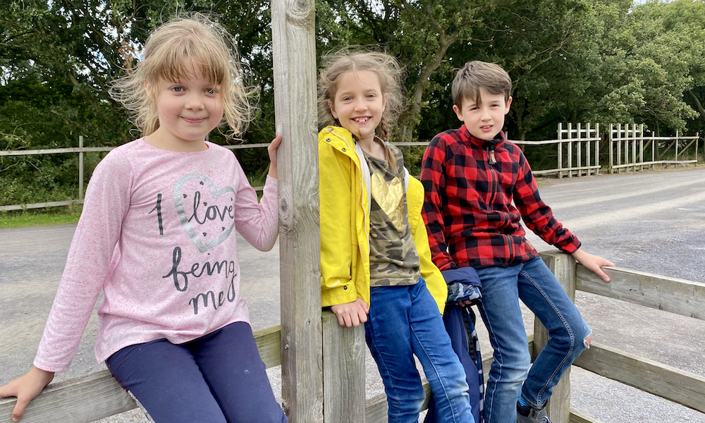 Whats on September for kids in Manchester three kids on a fence in autumn clothes